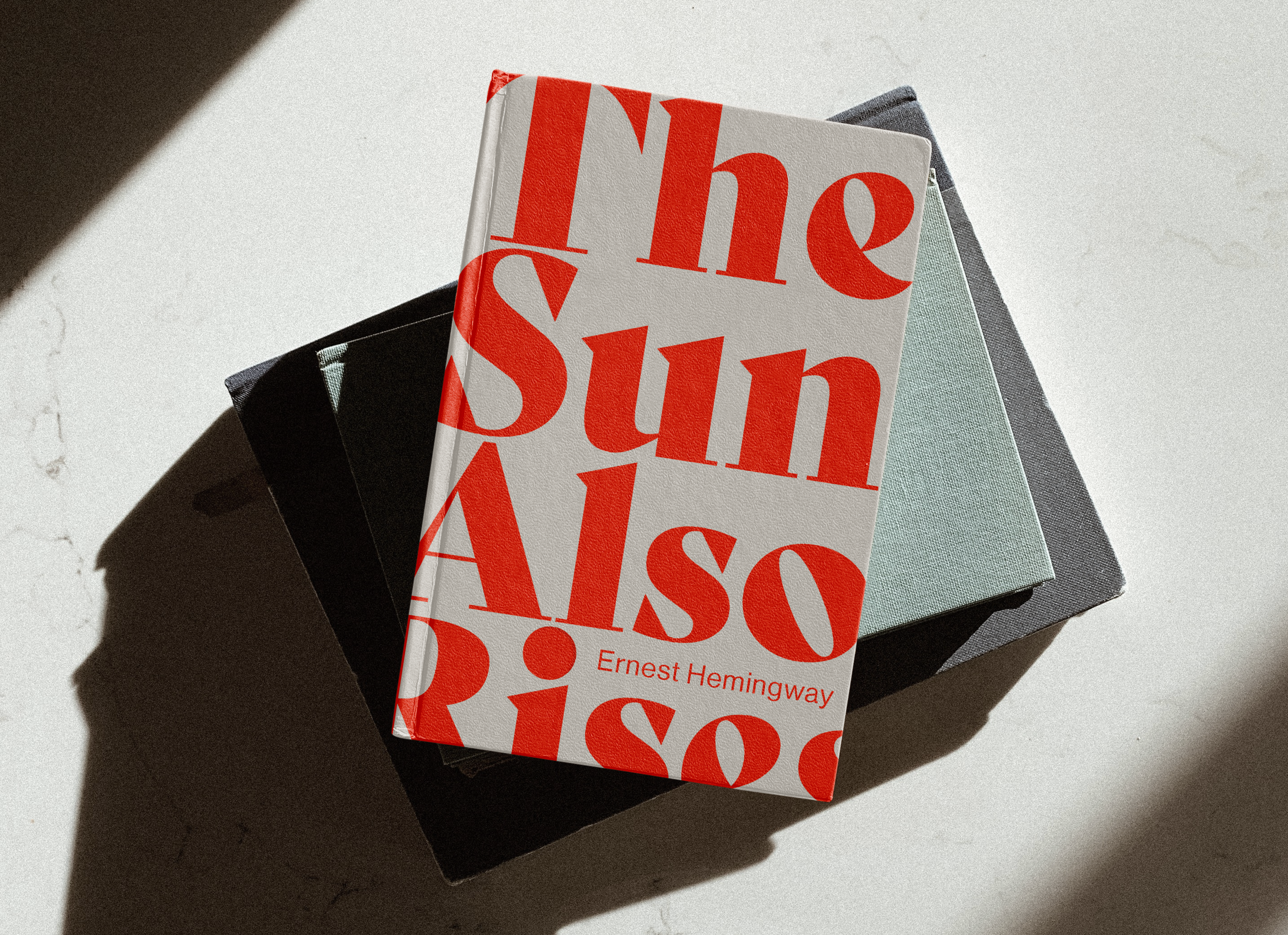 Mock up of The Sun Also Rises on top of a stack of books